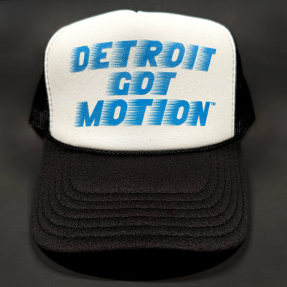 Black and white trucker hat with blue 'Detroit Got Motion' logo