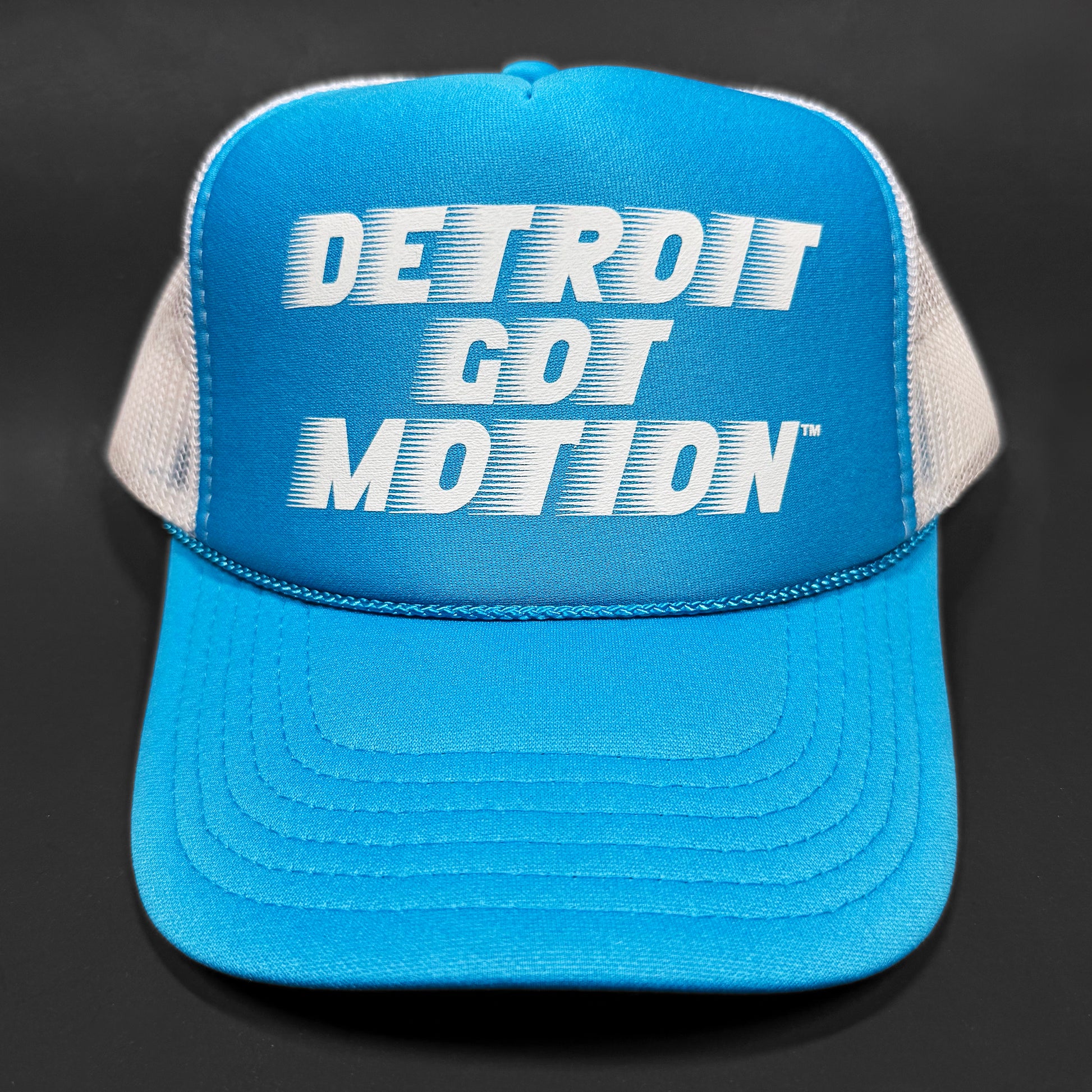 Blue cap with 'Detroit Got Motion' text on a black background