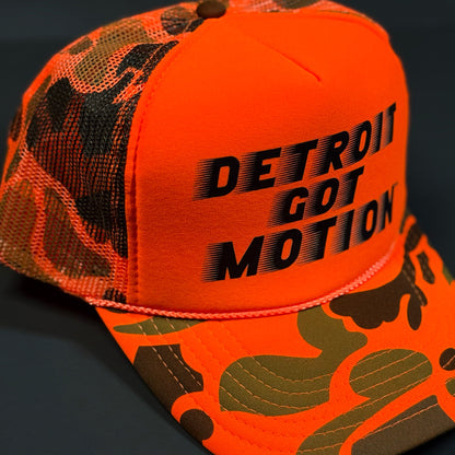 DETROIT GOT MOTION™ – TRUCKER HAT (Hi-Vis Orange Camo)