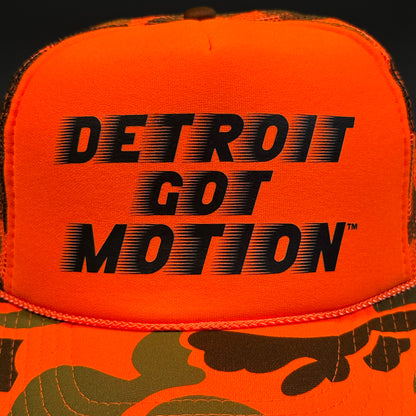 DETROIT GOT MOTION™ – TRUCKER HAT (Hi-Vis Orange Camo)