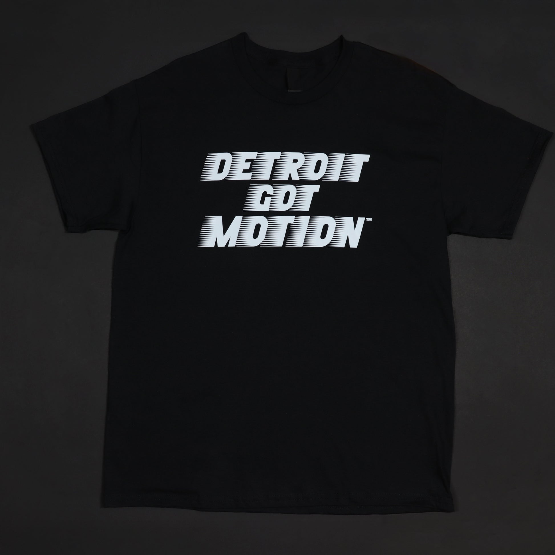 Black t-shirt with 'DETROIT GOT MOTION' text on a dark background